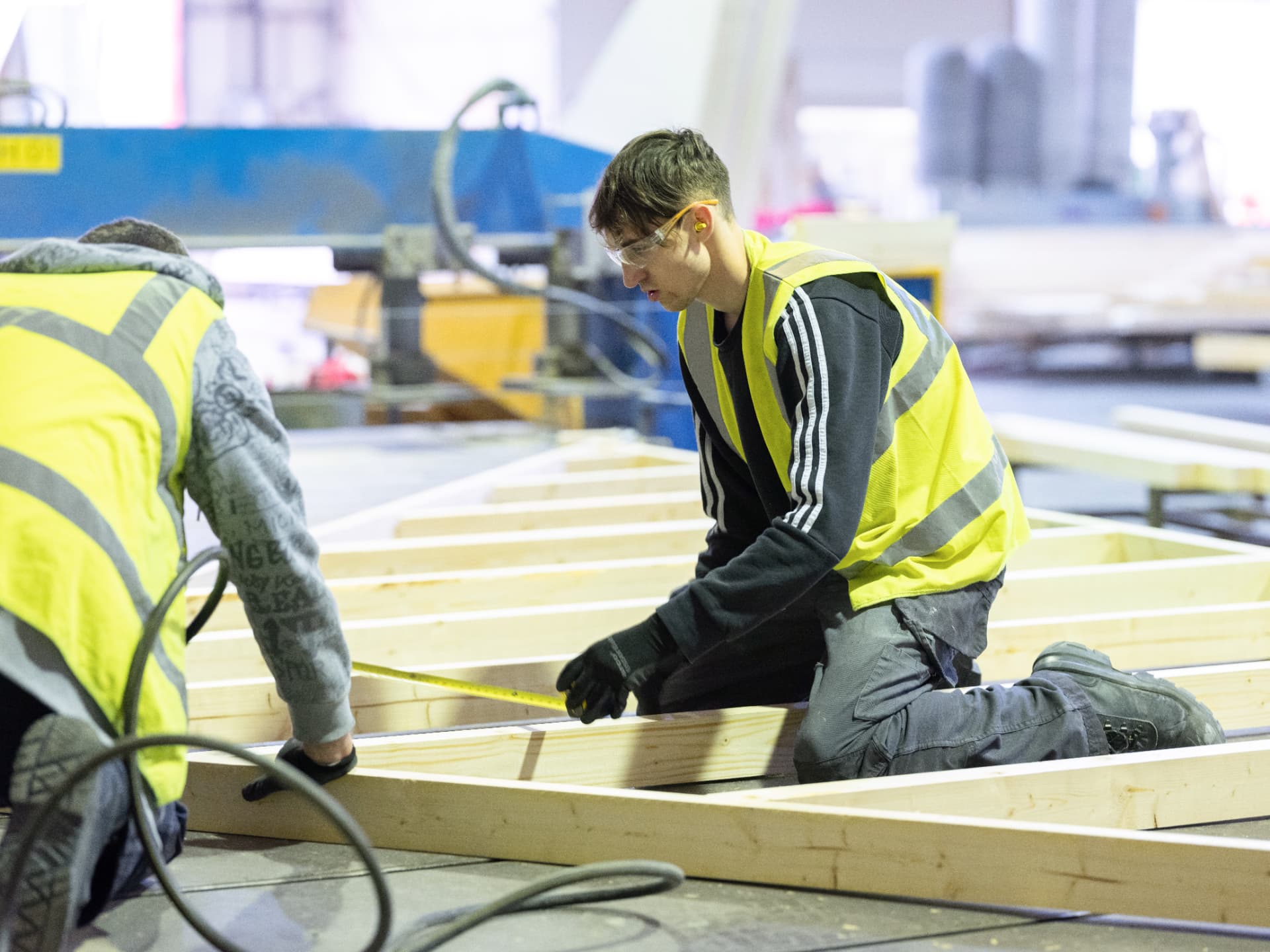 Two DTE operatives measuring an engineered timber floor cassette