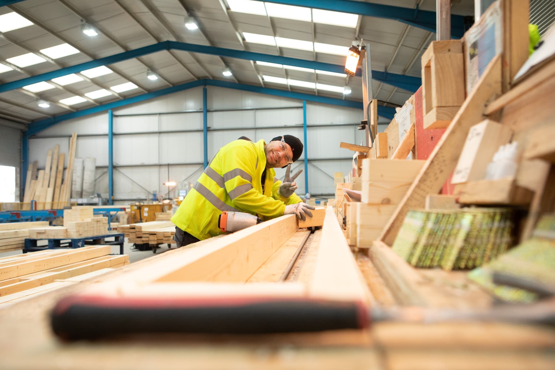 DTE operative smiling while nailing a timber component