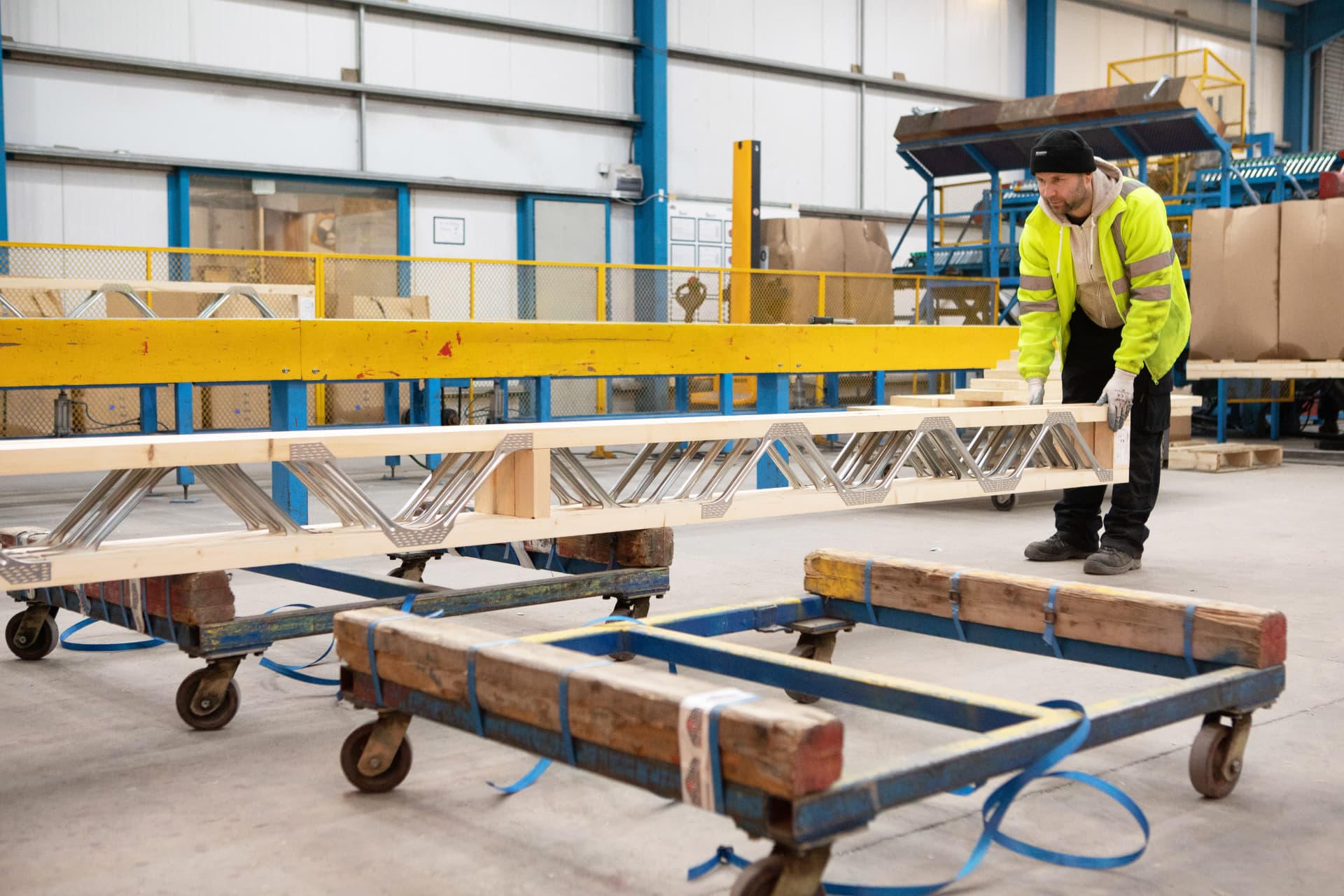 Finished Posi-Joist with steel web being moved onto a trolley
